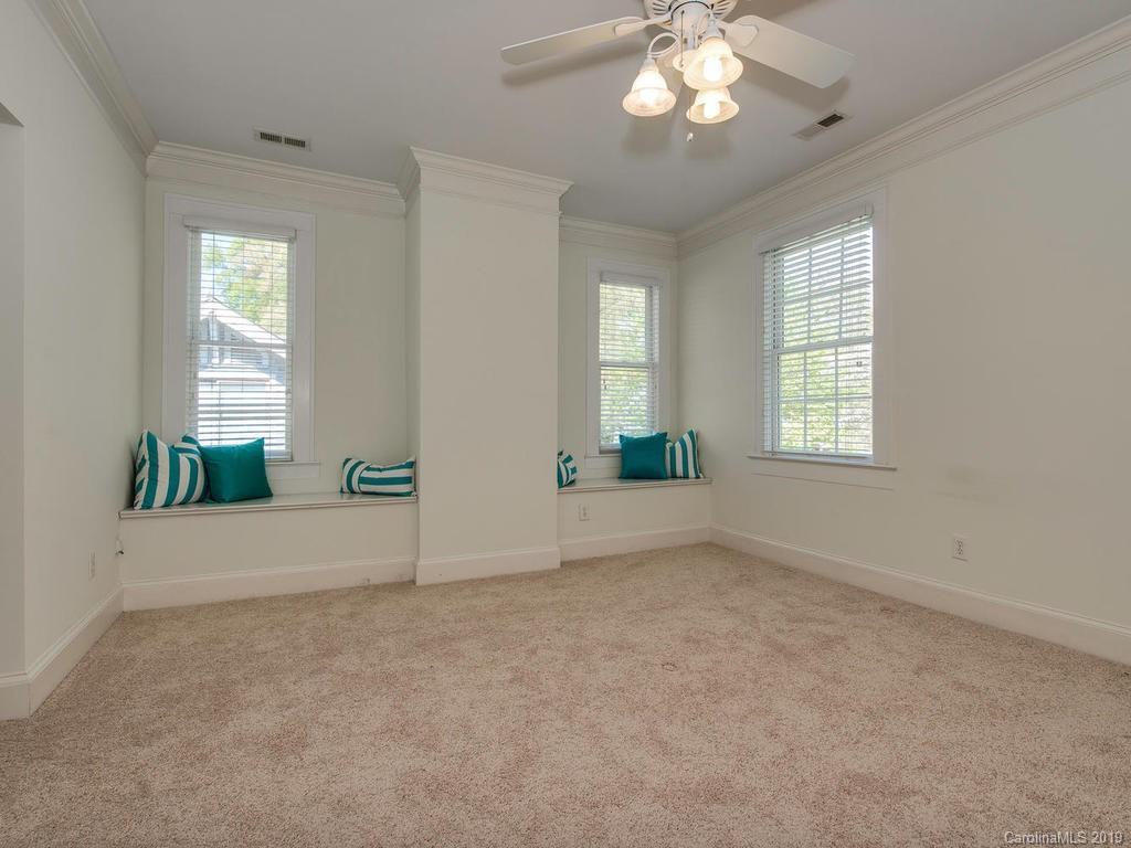 1614 Park Road Charlotte, NC 28203 - Photo 13 of 28 an empty room with windows and chandelier fan