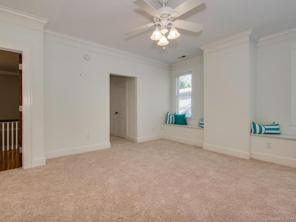 1614 Park Road Charlotte, NC 28203 - Photo 14 of 28 an empty room with windows and ceiling fan