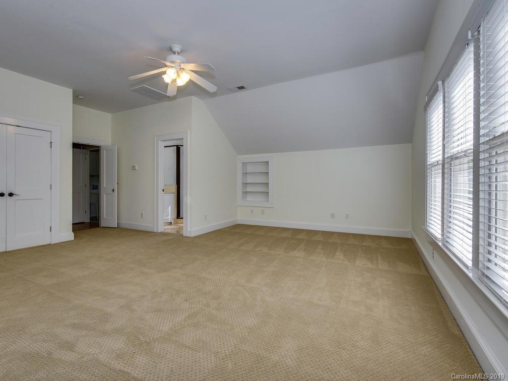 1614 Park Road Charlotte, NC 28203 - Photo 21 of 28 an empty room with a chandelier fan and windows