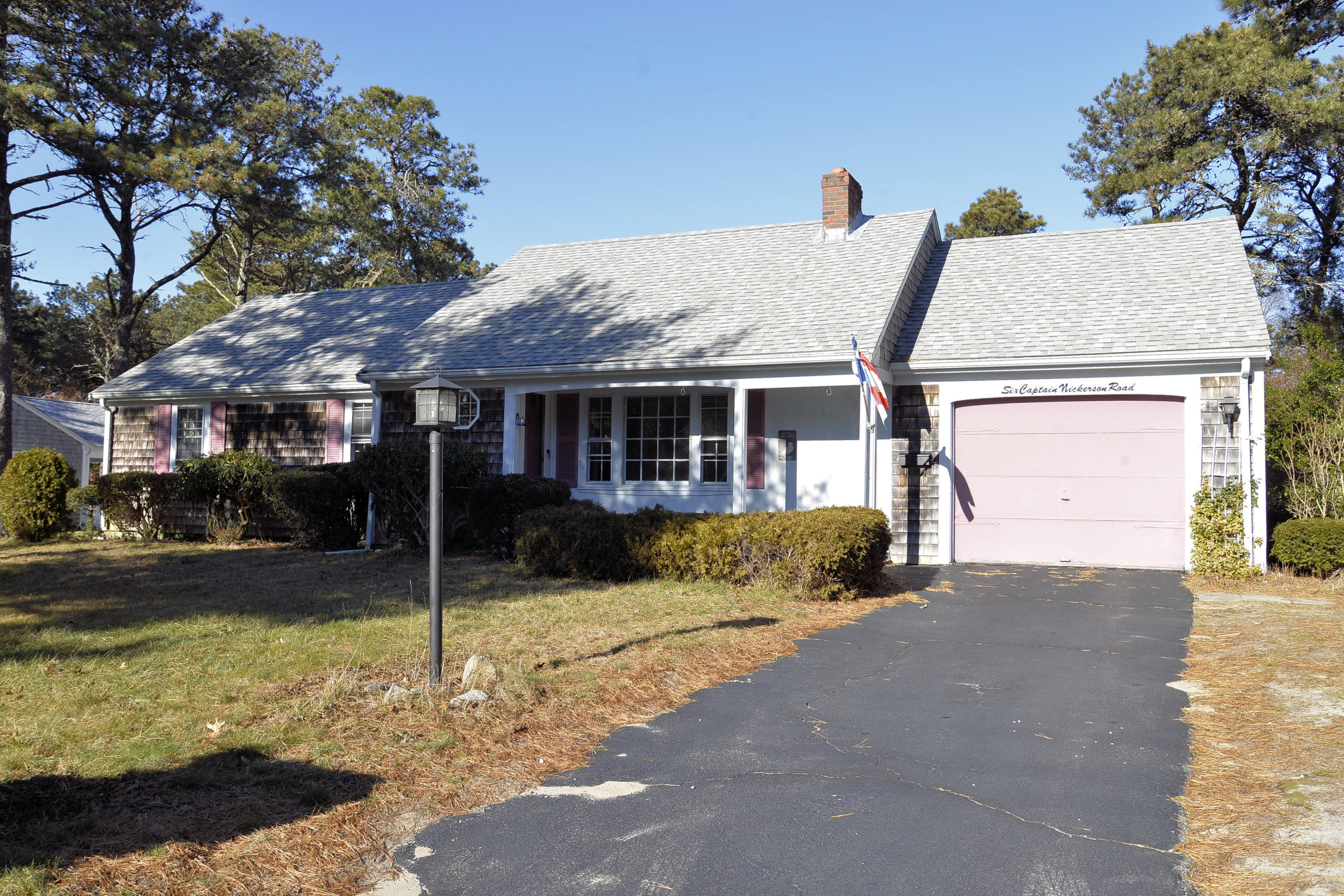 6 Captain Nickerson Road South Yarmouth, MA 02664 - Photo 1 of 20 a front view of a house with a yard and garage