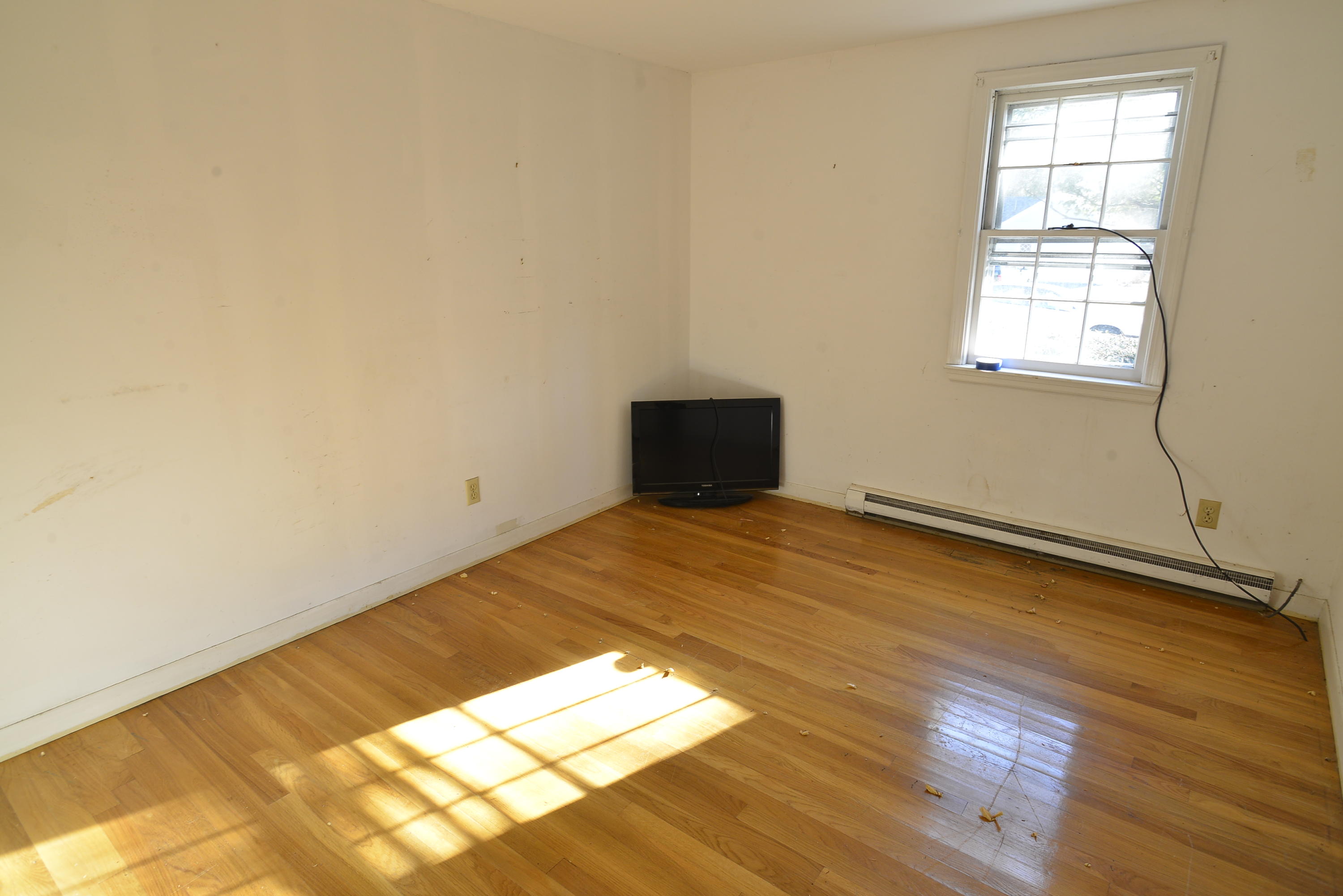 6 Captain Nickerson Road South Yarmouth, MA 02664 - Photo 11 of 20 an empty room with wooden floor and windows
