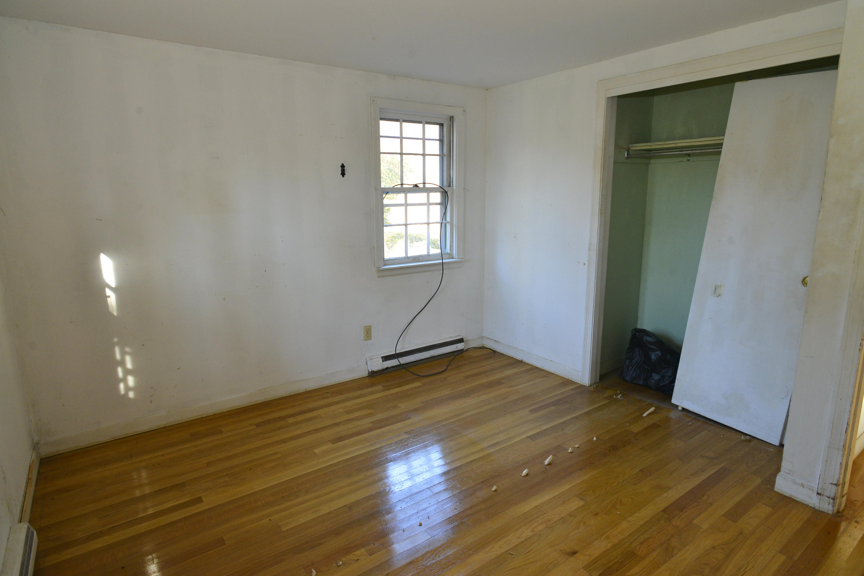 6 Captain Nickerson Road South Yarmouth, MA 02664 - Photo 12 of 20 an empty room with wooden floor and windows