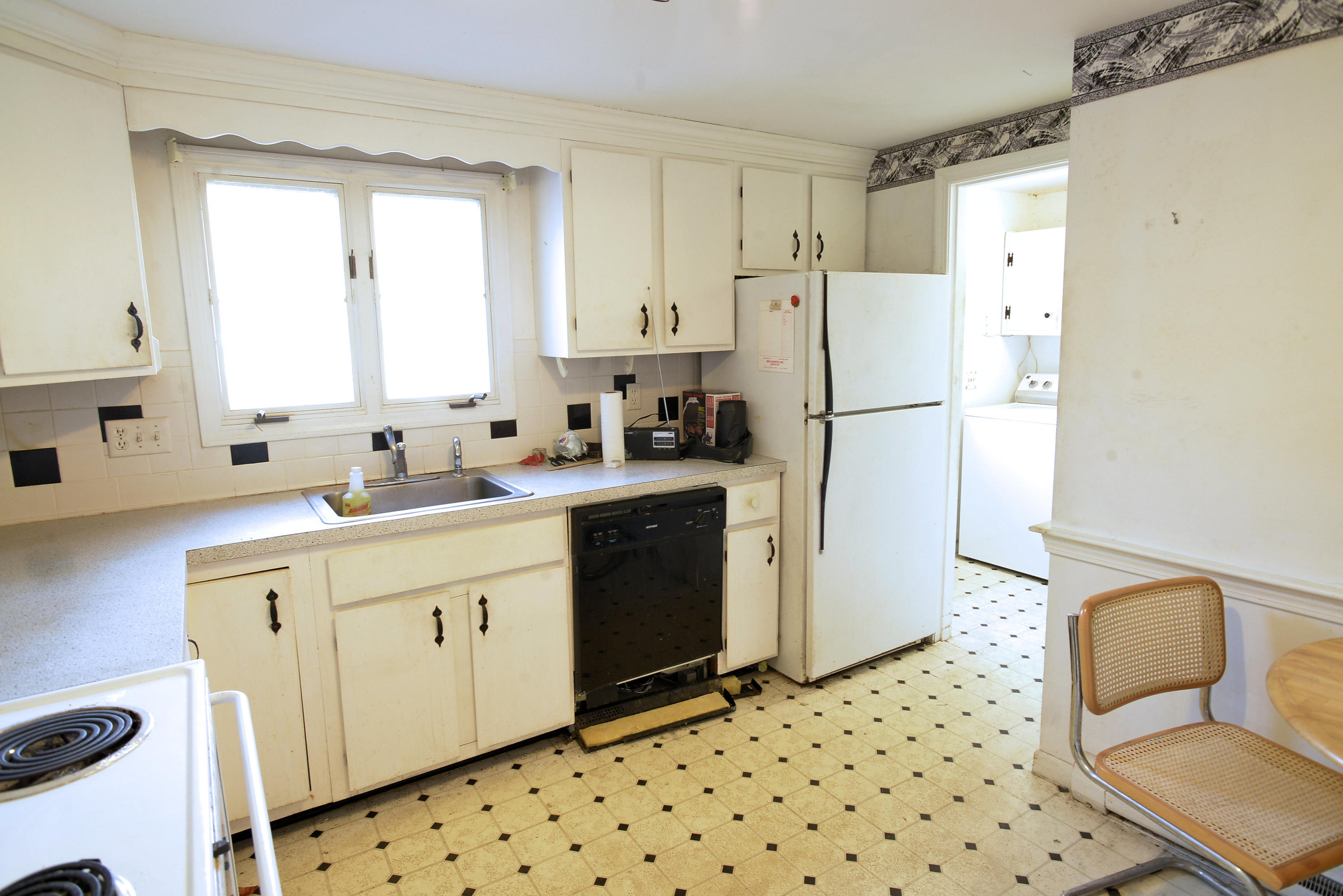 6 Captain Nickerson Road South Yarmouth, MA 02664 - Photo 3 of 20 a kitchen with sink a refrigerator and white cabinets