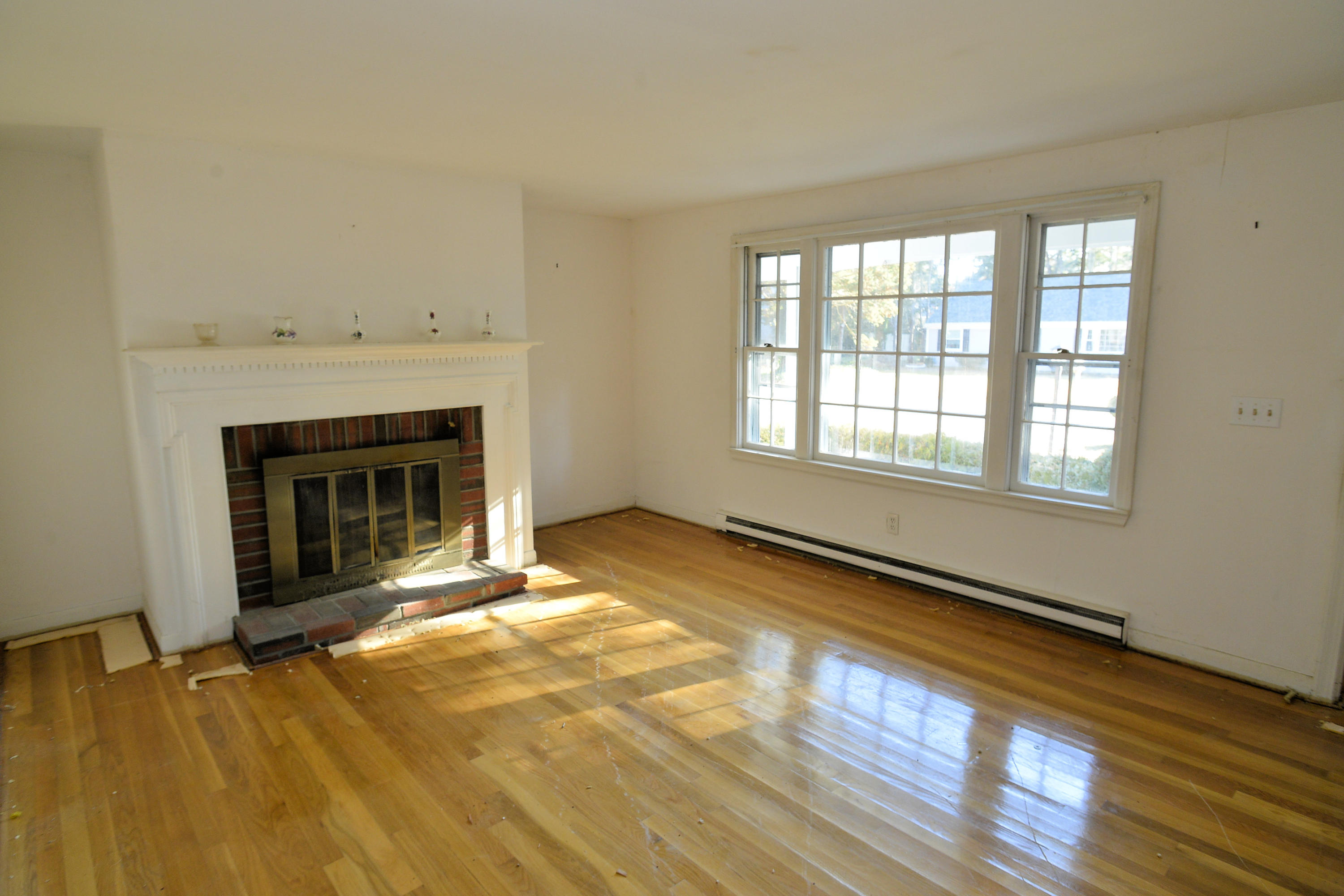 6 Captain Nickerson Road South Yarmouth, MA 02664 - Photo 7 of 20 a view of an empty room with a fireplace and a window