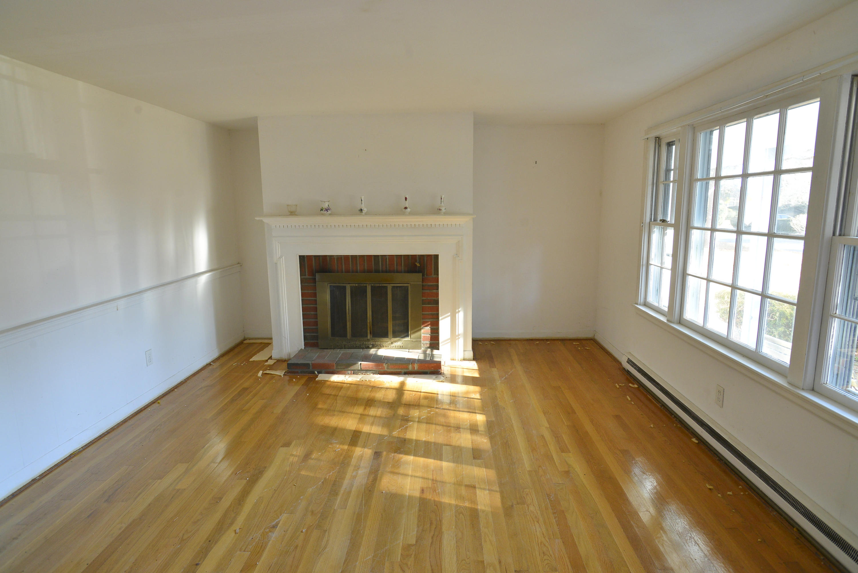 6 Captain Nickerson Road South Yarmouth, MA 02664 - Photo 8 of 20 a view of an empty room with a fireplace and a window