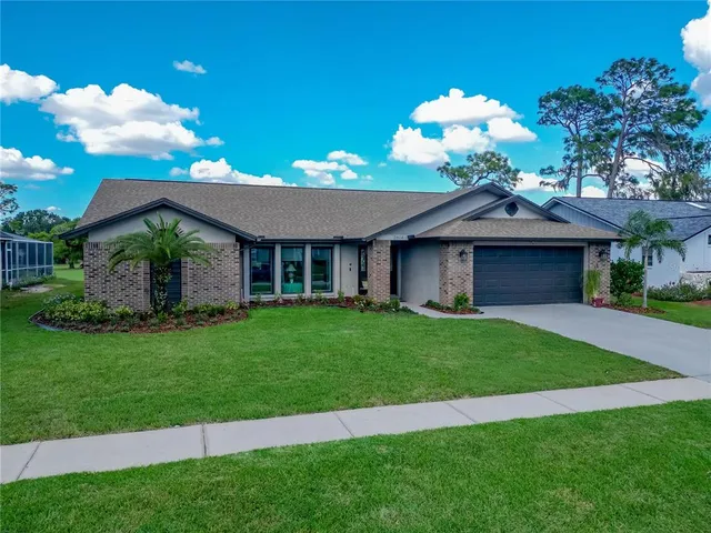 a front view of a house with a garden and yard