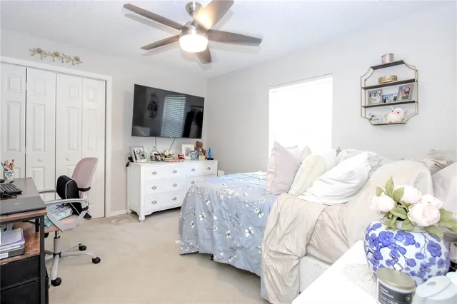 a bedroom with furniture and a flat screen tv