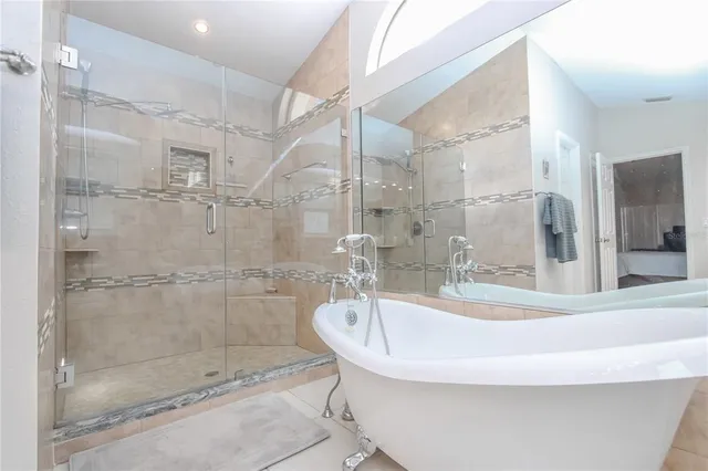 a bath tub sitting next to a shower