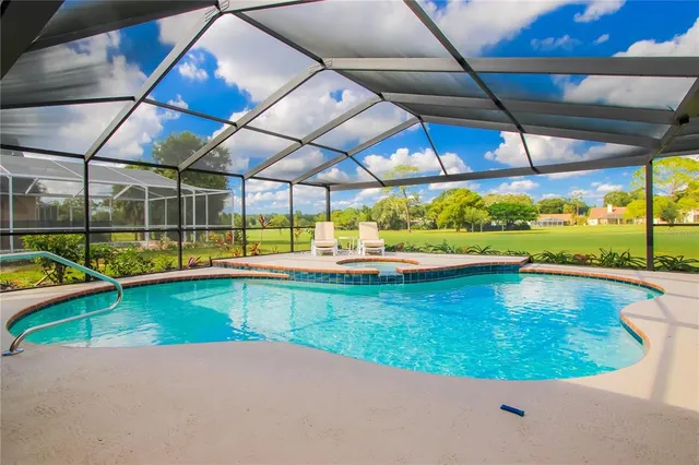 a view of a swimming pool with a yard