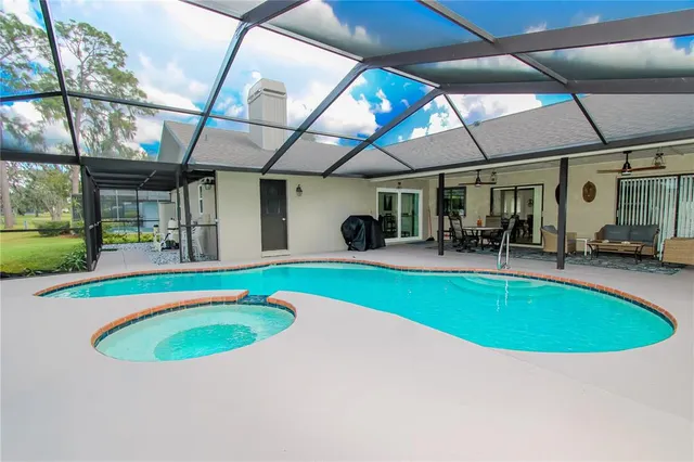 an outdoor space with swimming pool and furniture