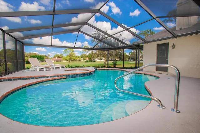 a view of a swimming pool with a patio