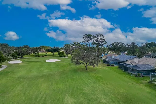 a view of a golf course with a lake view
