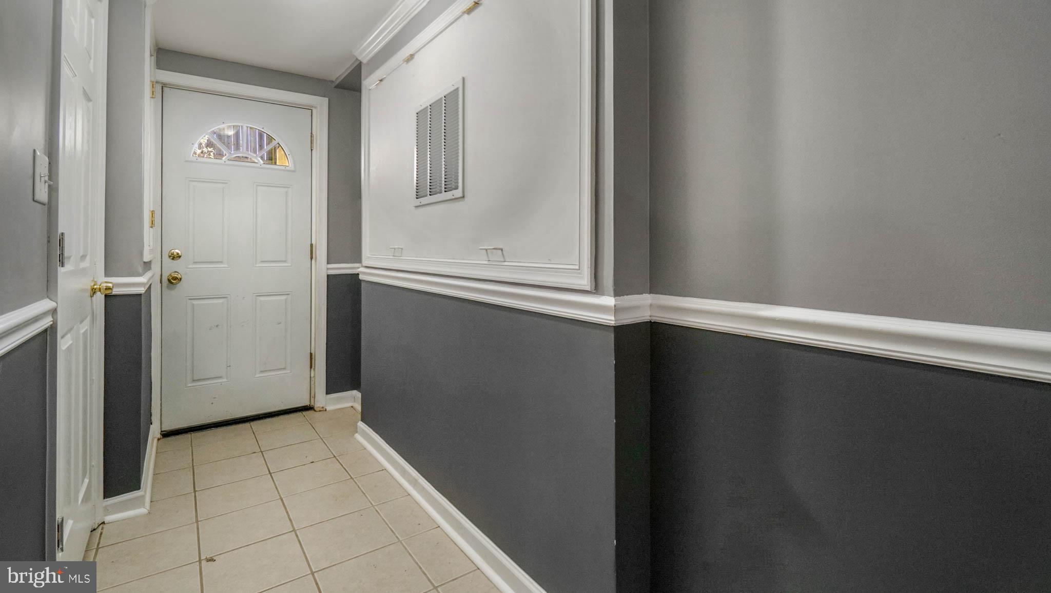 917 Oakleigh Beach Road Baltimore, MD 21222 - Photo 19 of 27 Basement door to outside and under stairs storage