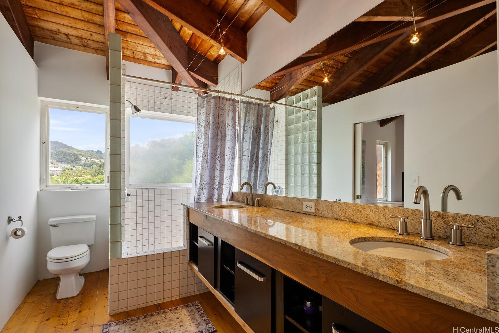 8 Prospect Street Honolulu, HI 96813 - Photo 11 of 25 a bathroom with a granite countertop sink toilet and shower