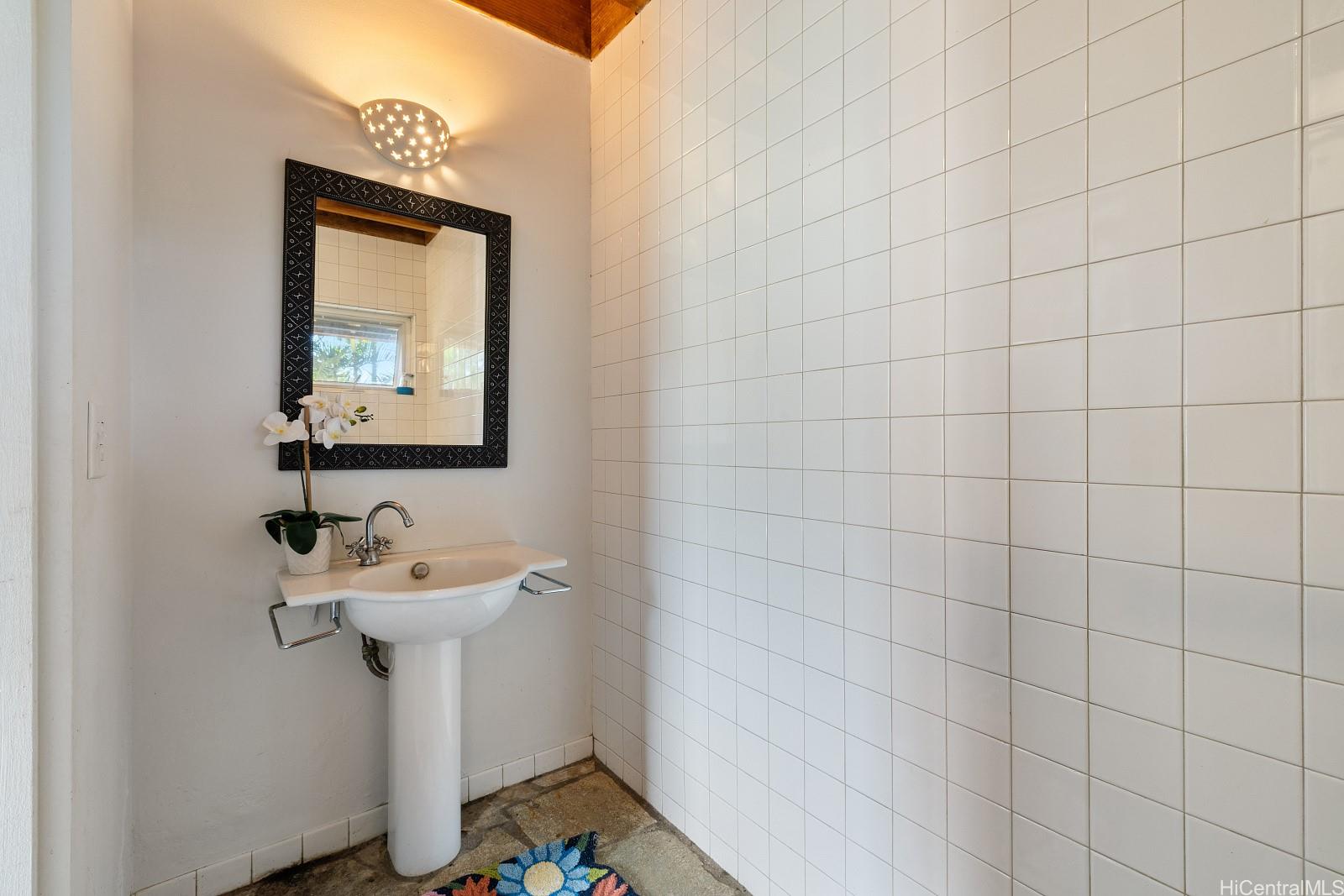 8 Prospect Street Honolulu, HI 96813 - Photo 15 of 25 a bathroom with a sink a mirror and toilet