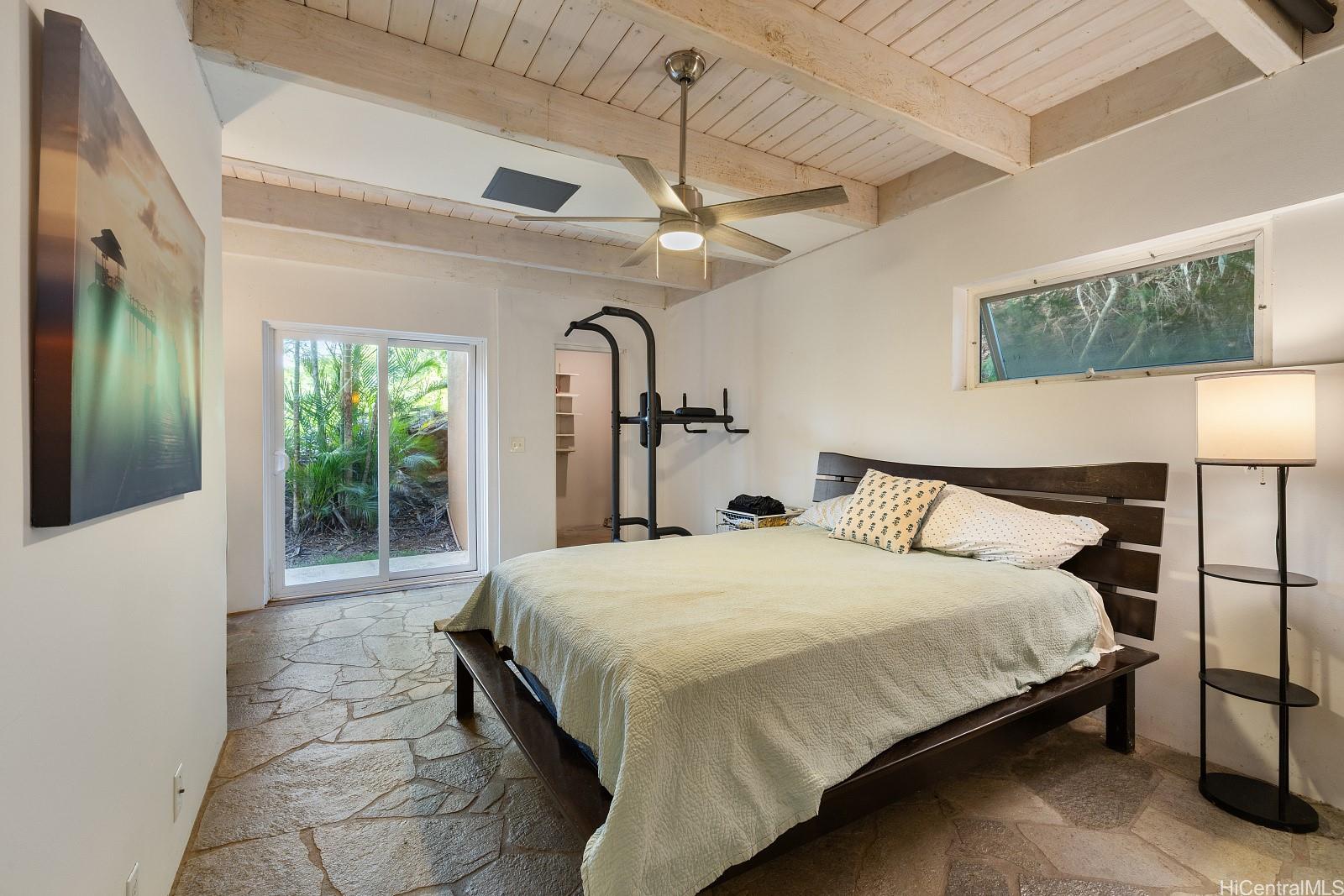8 Prospect Street Honolulu, HI 96813 - Photo 16 of 25 a bedroom with a large bed and a chandelier