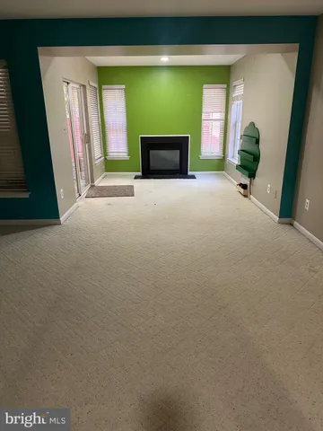 a view of a livingroom with an empty space and a fireplace