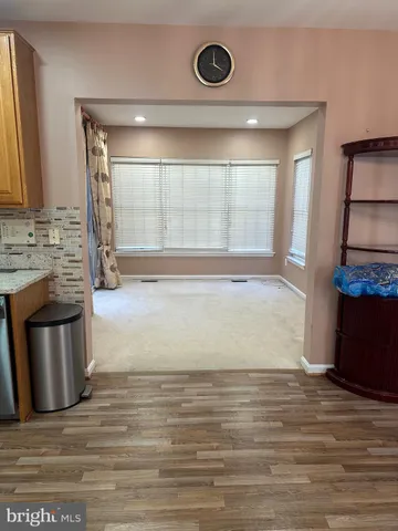 a view of a kitchen with a sink and a fireplace
