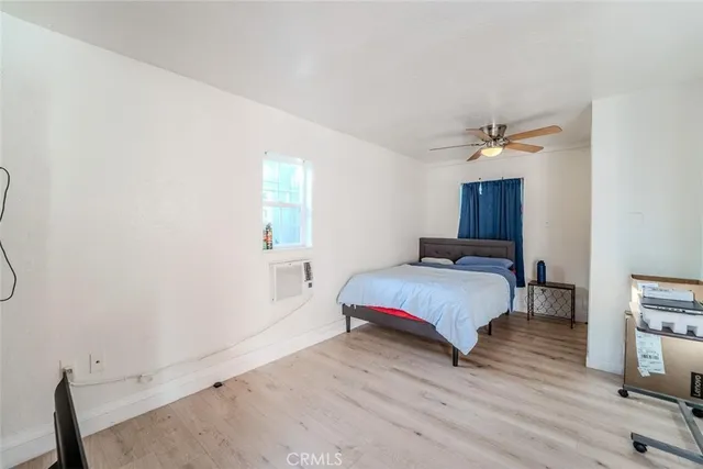 a spacious bedroom with a bed and a chandelier