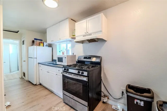 a kitchen with a stove and a refrigerator