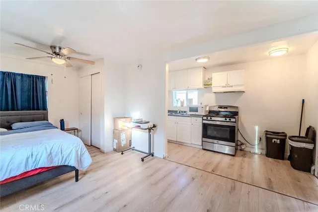 a bedroom with a bed and a view of kitchen