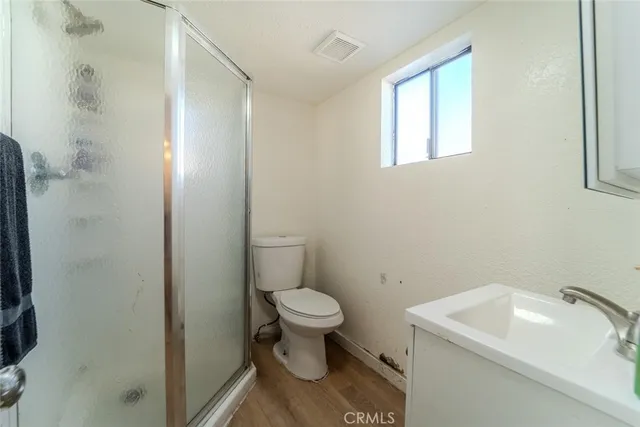 a bathroom with a sink toilet and window