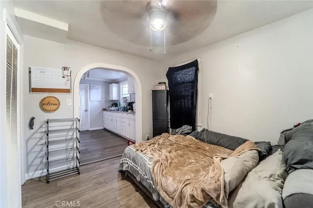 a bedroom with a bed and a mirror on the dresser