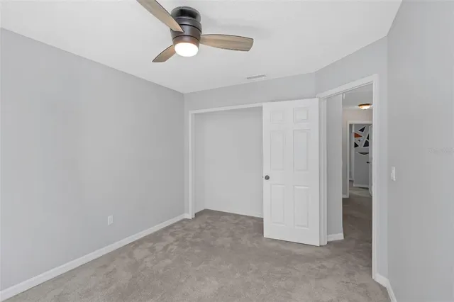 an empty room with a empty space and a ceiling fan