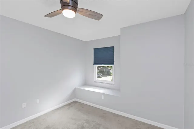 a white toilet sitting next to a white wall