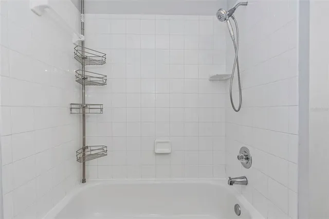 a bathroom with a bathtub and shower