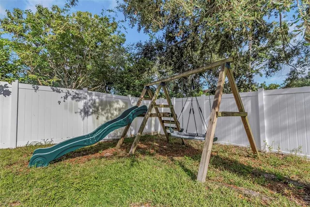 a backyard of a house with yard and outdoor seating