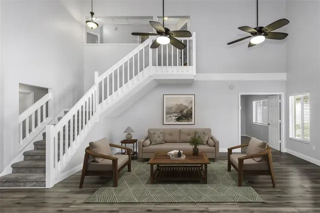 a living room with furniture and a ceiling fan