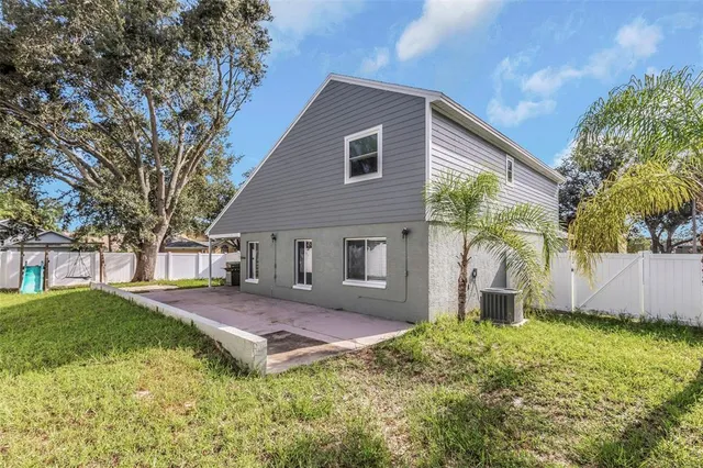 a house that has a tree in front of the house