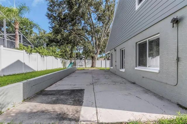 a aerial view of a house with a yard and potted plants