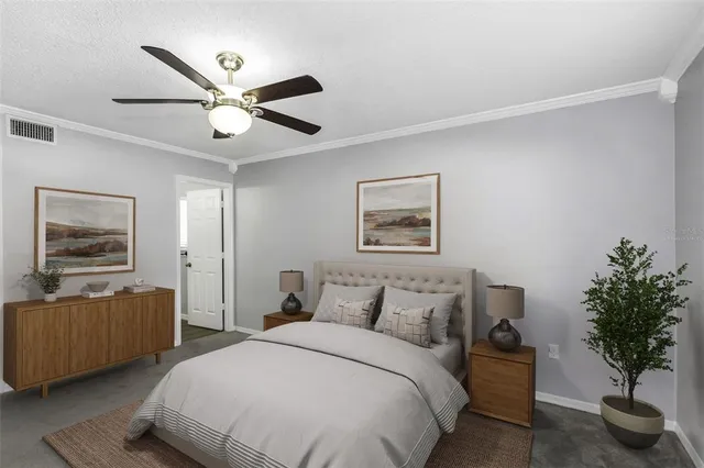 a bedroom with bed and a potted plant