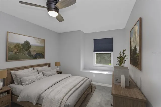 a bedroom with a bed and a painting on the wall