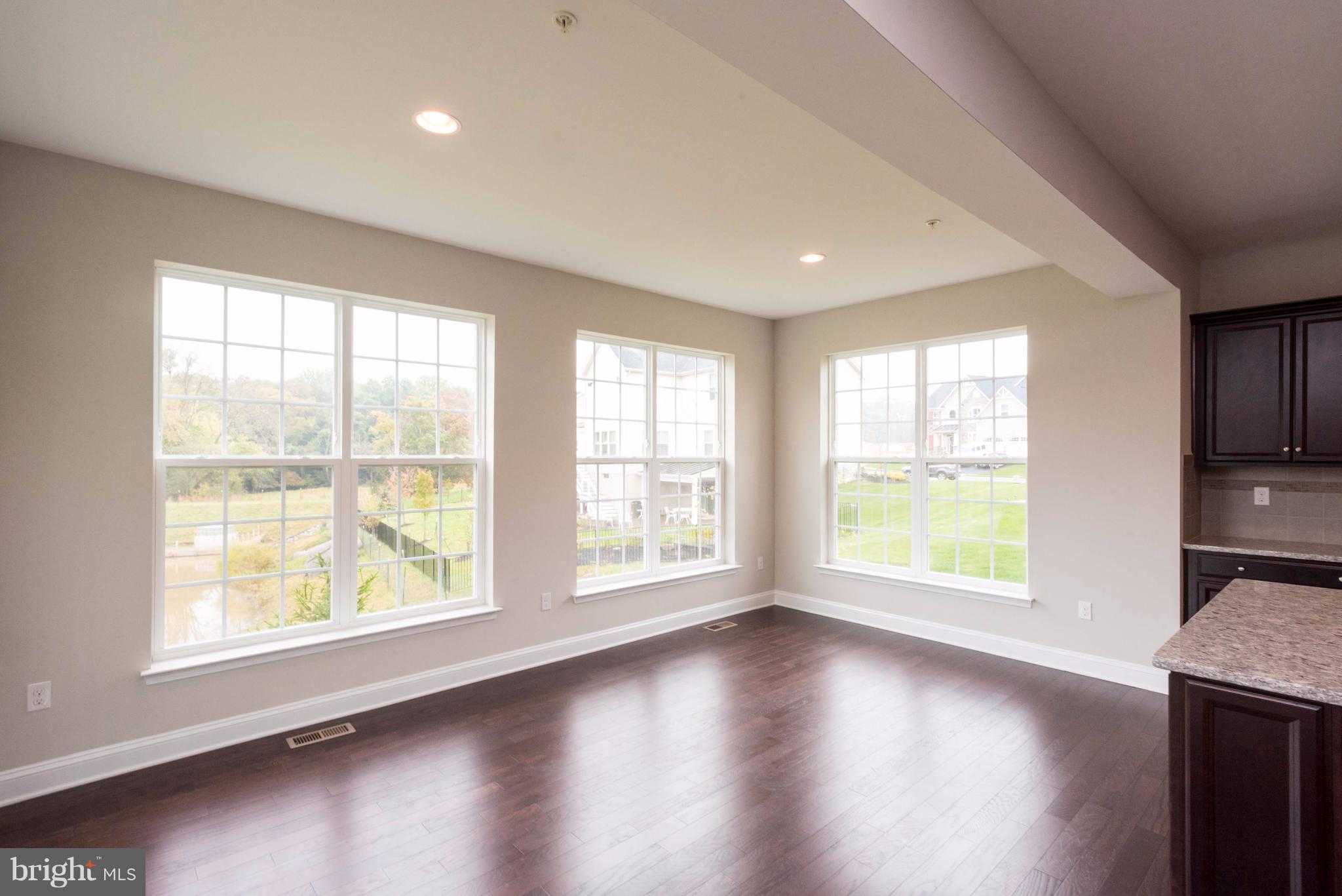 9766 Powder Hall Road Perry Hall, MD 21128 - Photo 14 of 30 an empty room with wooden floor and windows