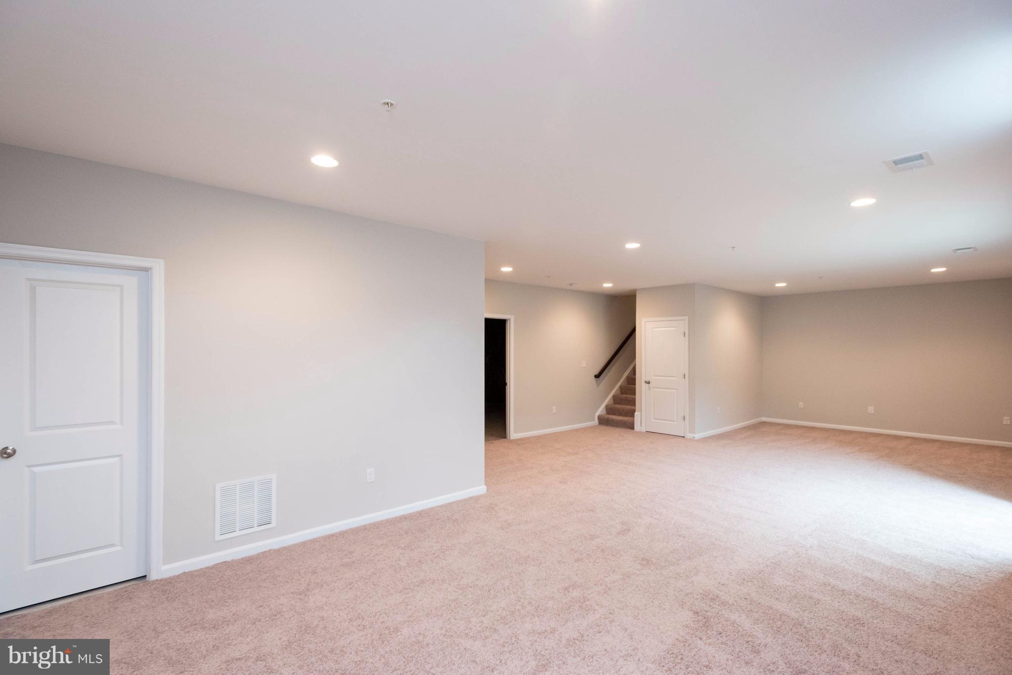 9766 Powder Hall Road Perry Hall, MD 21128 - Photo 25 of 30 an empty room with kitchen view and natural light