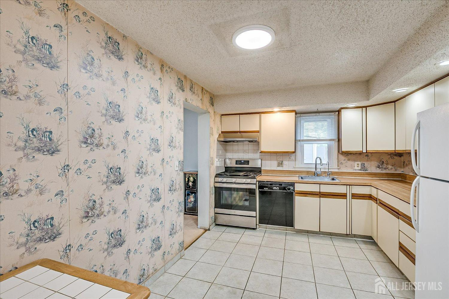 4702 Hana Road Edison, NJ 08817 - Photo 12 of 28 a kitchen with stainless steel appliances a stove sink and cabinets
