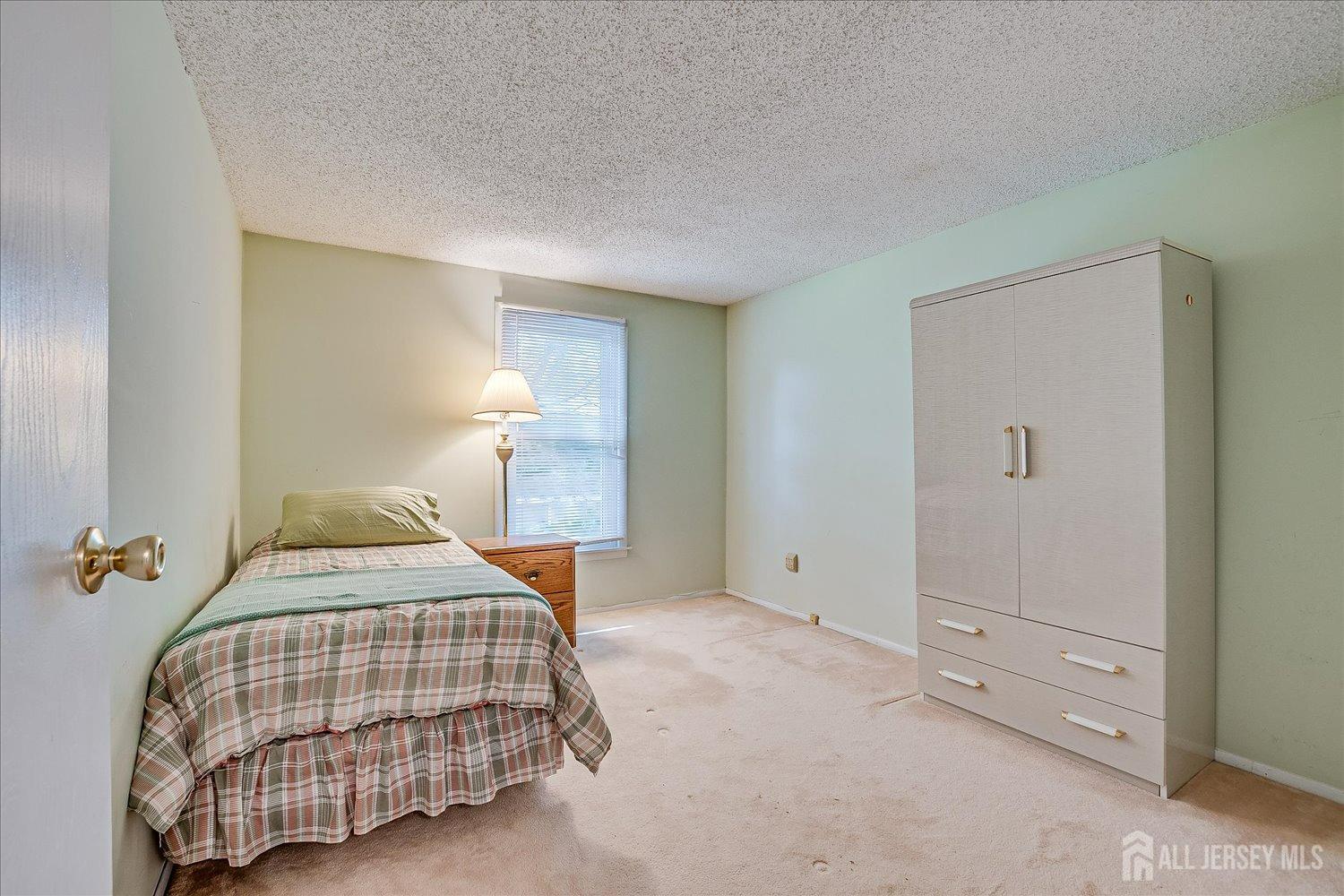 4702 Hana Road Edison, NJ 08817 - Photo 21 of 28 a bedroom with a bed and window