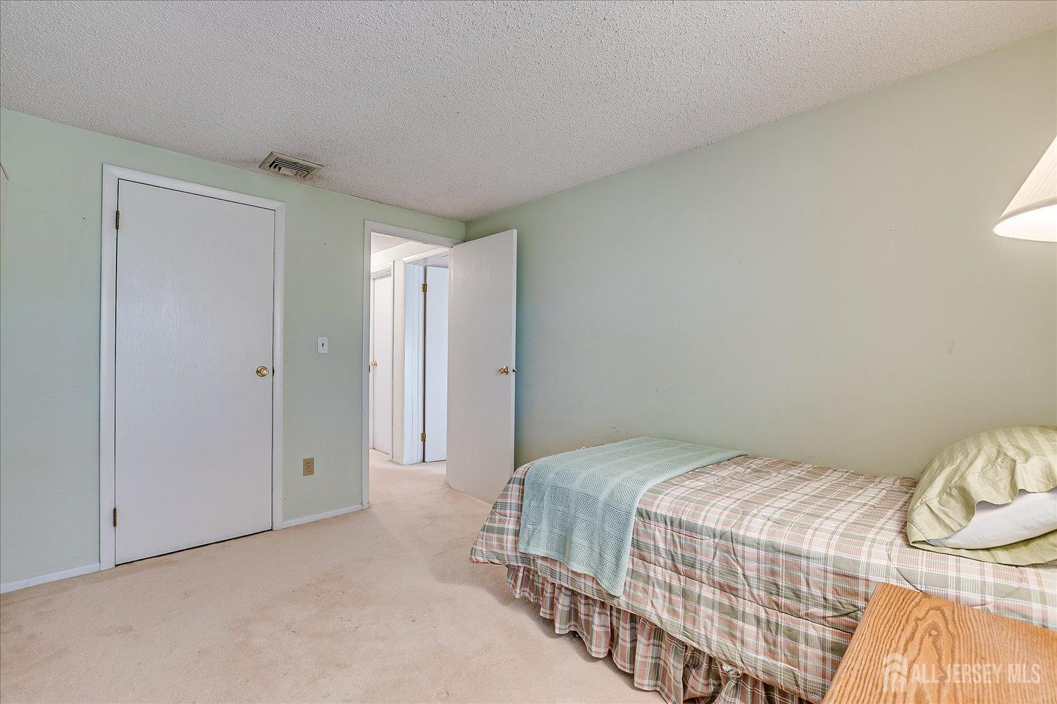 4702 Hana Road Edison, NJ 08817 - Photo 22 of 28 a bedroom with a bed and a window