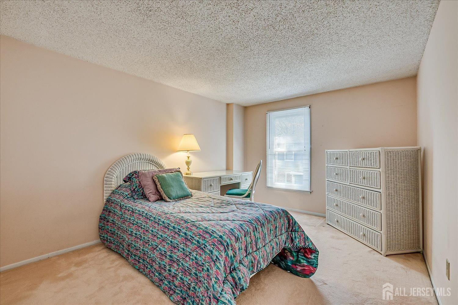 4702 Hana Road Edison, NJ 08817 - Photo 23 of 28 a bedroom with a bed and a cabinets
