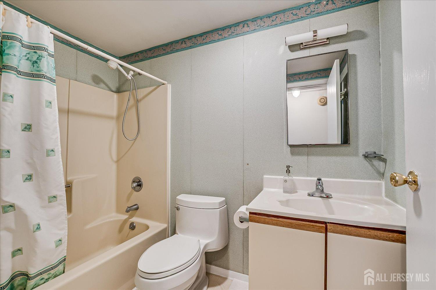 4702 Hana Road Edison, NJ 08817 - Photo 25 of 28 a bathroom with a granite countertop sink toilet and shower