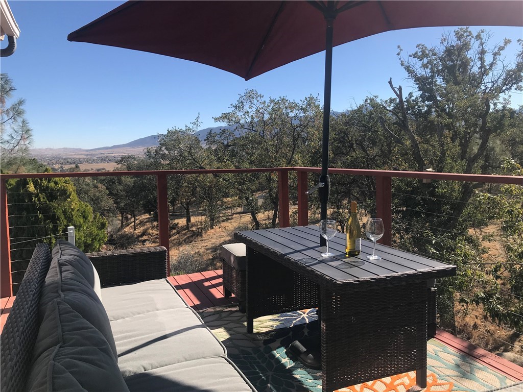 21600 Quail Springs Road Tehachapi, CA 93561 - Photo 1 of 1 a view of a balcony with couches and wooden floor