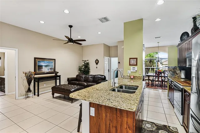 a kitchen with counter top space appliances and a ceiling fan