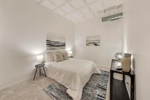 a bedroom with a bed and a night stand