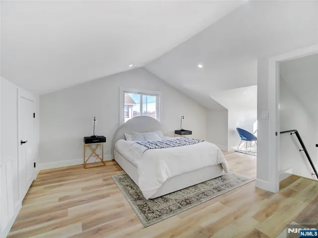 a bedroom with a bed and a large mirror