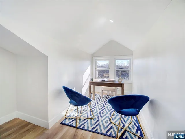 a view of a room with a table and chairs