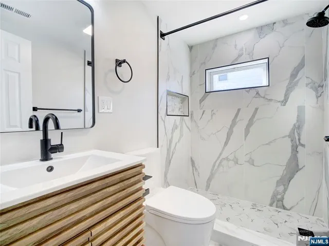 a bathroom with a sink toilet and shower