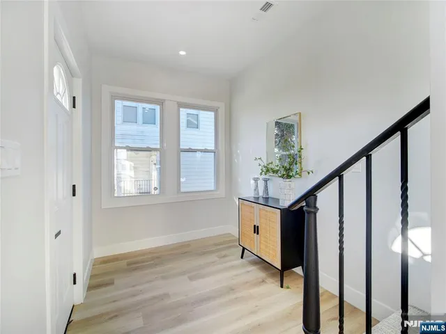 a view of entryway with wooden floor and stairs